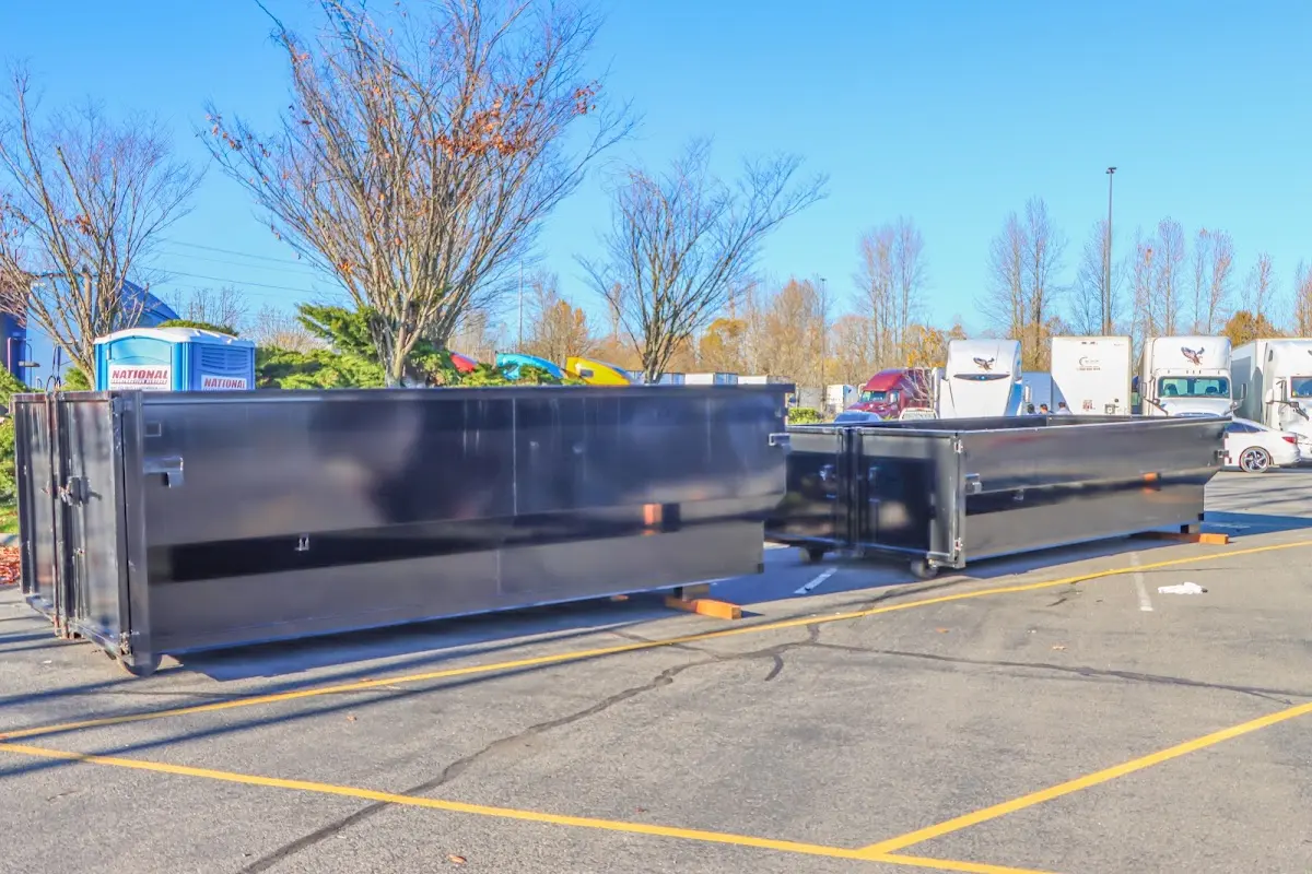 Professional dumpster rental service with roll-off container on residential driveway in Sappington